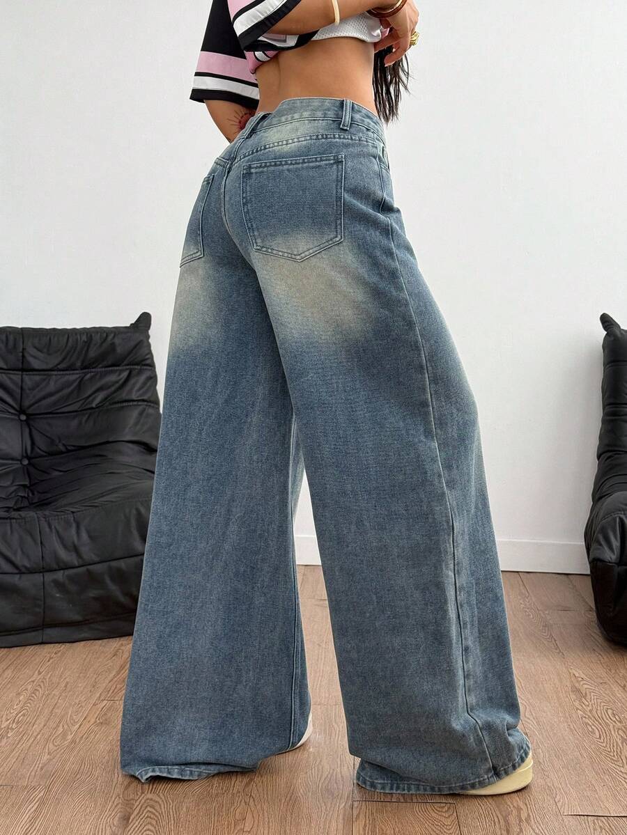 Loose wide leg denim jeans for women featuring a low waist, functional pockets, zipper fly closure, and extra long relaxed fit.