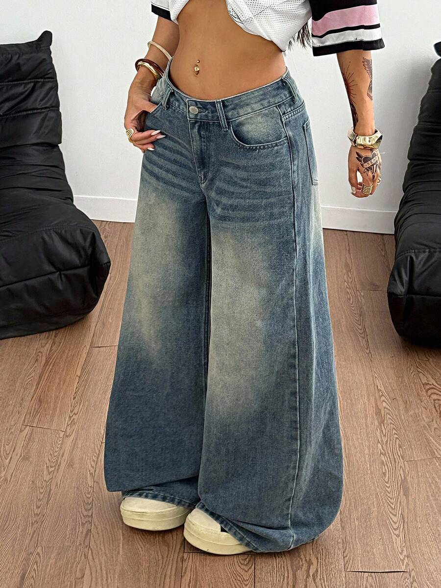 Loose wide leg denim jeans for women featuring a low waist, functional pockets, zipper fly closure, and extra long relaxed fit.
