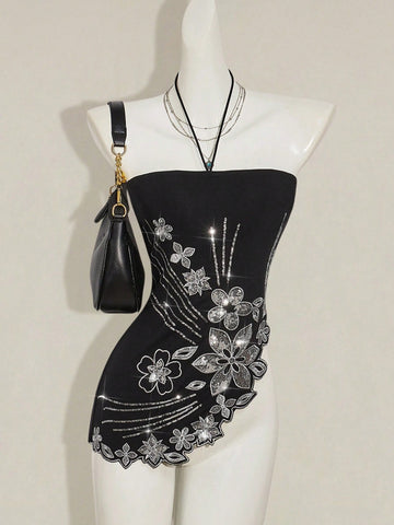Women's black asymmetrical knitted halter top featuring a slim fit and colorblock pattern
