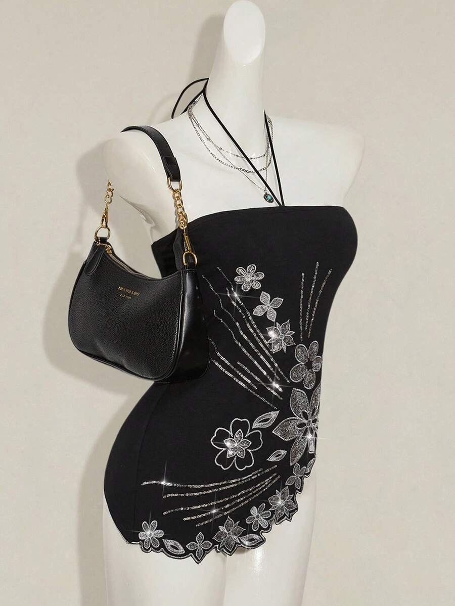 Women's black asymmetrical knitted halter top featuring a slim fit and colorblock pattern