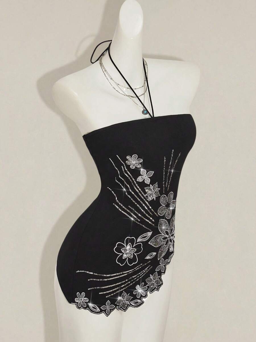 Women's black asymmetrical knitted halter top featuring a slim fit and colorblock pattern