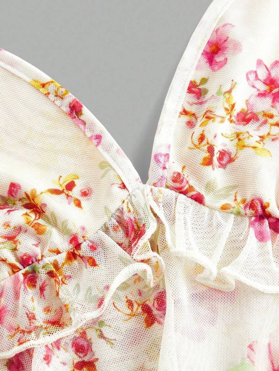 Floral multicolor mesh spaghetti strap cami tank top with backless design, ruffle hem, lettuce trim, and flared long loose fit.
