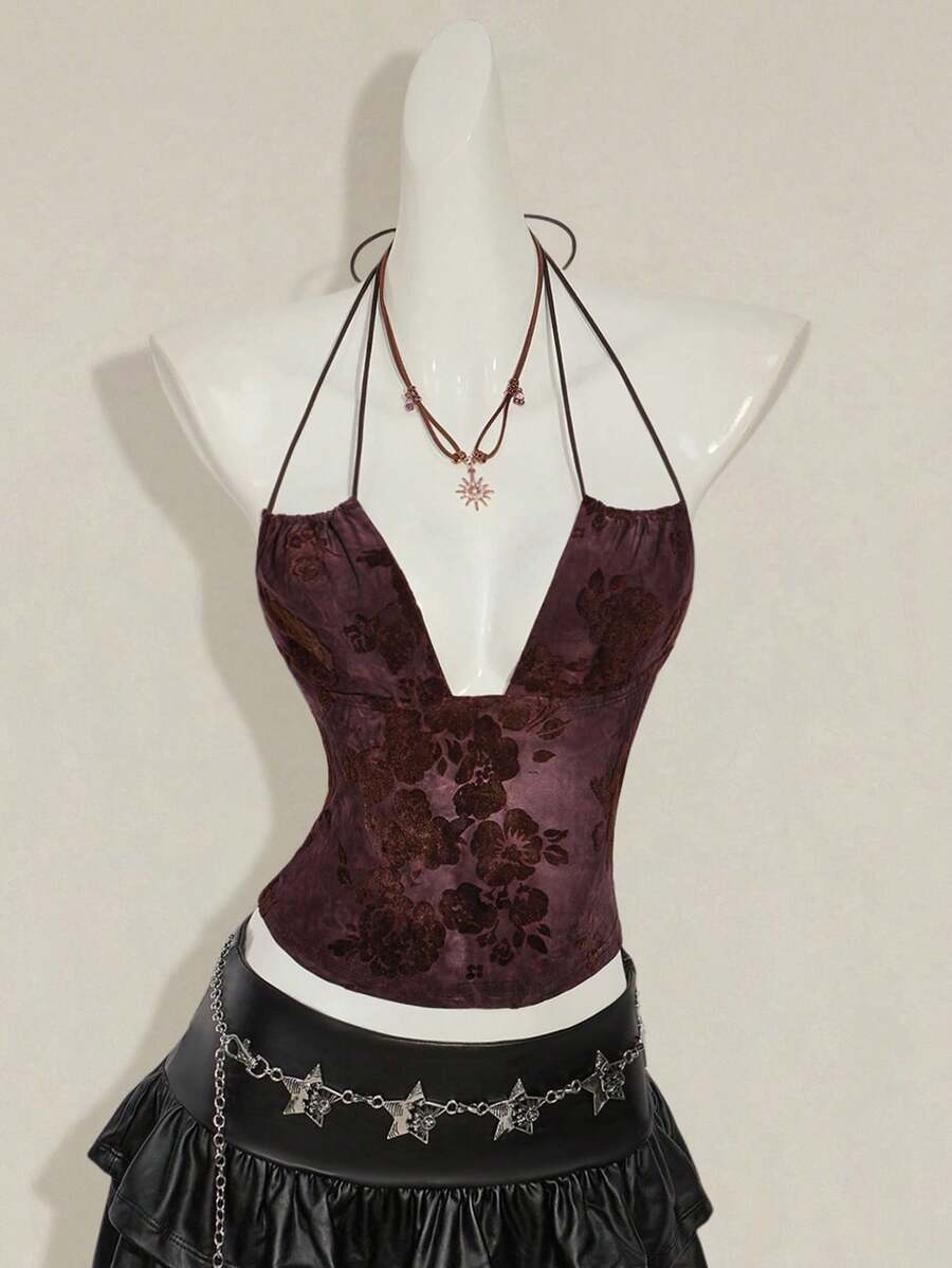 Women's green flocked jacquard halter tank top with plant pattern, criss-cross straps, deep V-back, knot detail, backless cut, and asymmetrical micro crop hem.