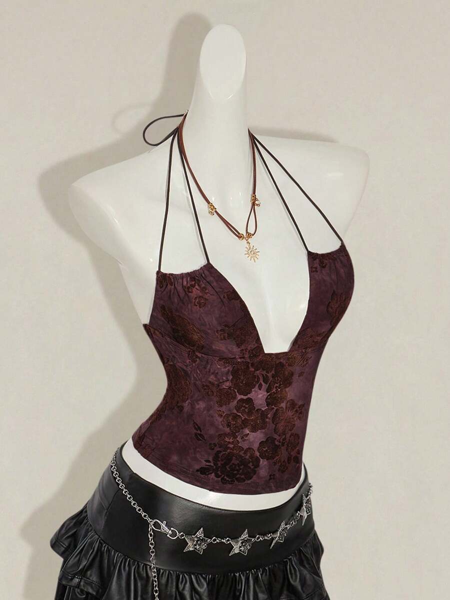 Women's green flocked jacquard halter tank top with plant pattern, criss-cross straps, deep V-back, knot detail, backless cut, and asymmetrical micro crop hem.