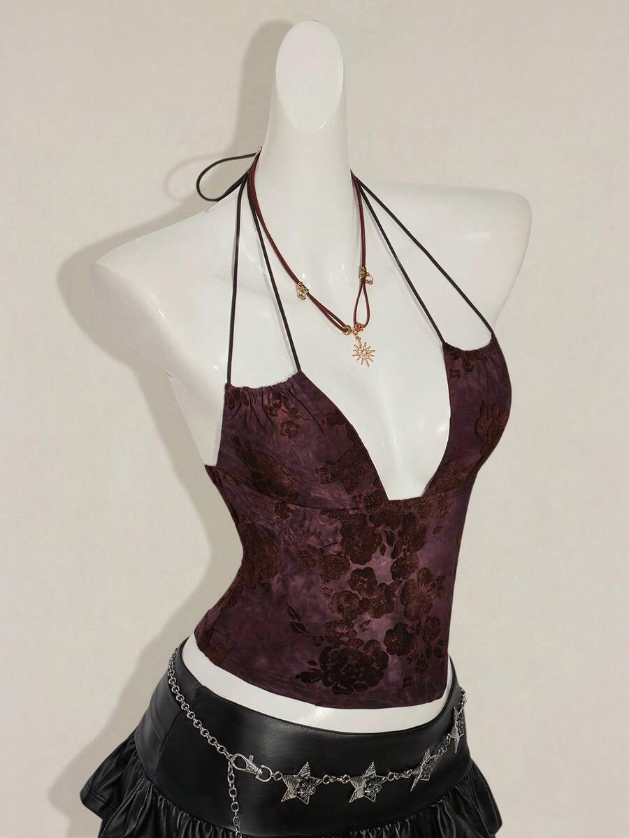 Women's green flocked jacquard halter tank top with plant pattern, criss-cross straps, deep V-back, knot detail, backless cut, and asymmetrical micro crop hem.