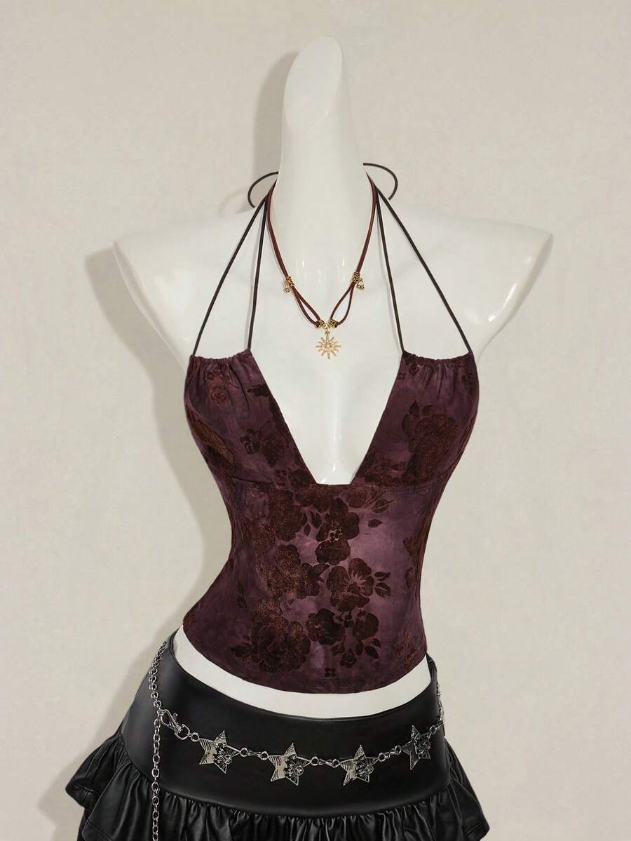 Women's green flocked jacquard halter tank top with plant pattern, criss-cross straps, deep V-back, knot detail, backless cut, and asymmetrical micro crop hem.