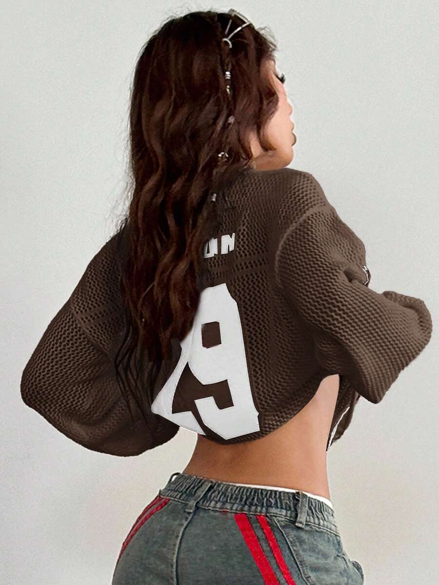 Women's oversized long sleeve knit pullover sweater with round neck, drop shoulder design, and front pocket detail.