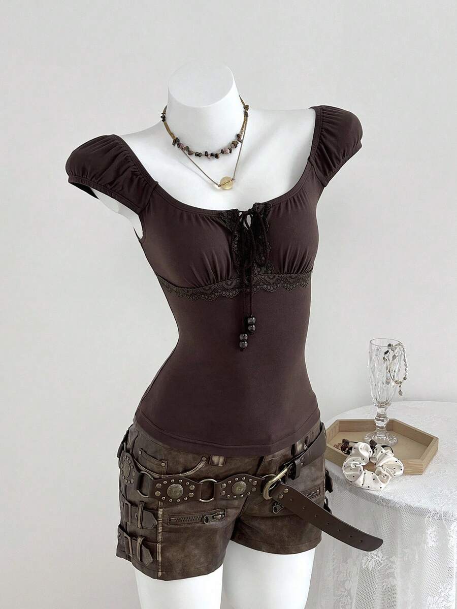 Women's brown slim-fit t-shirt with contrast lace trim, knot detail, scoop neck, and raglan cap sleeves.