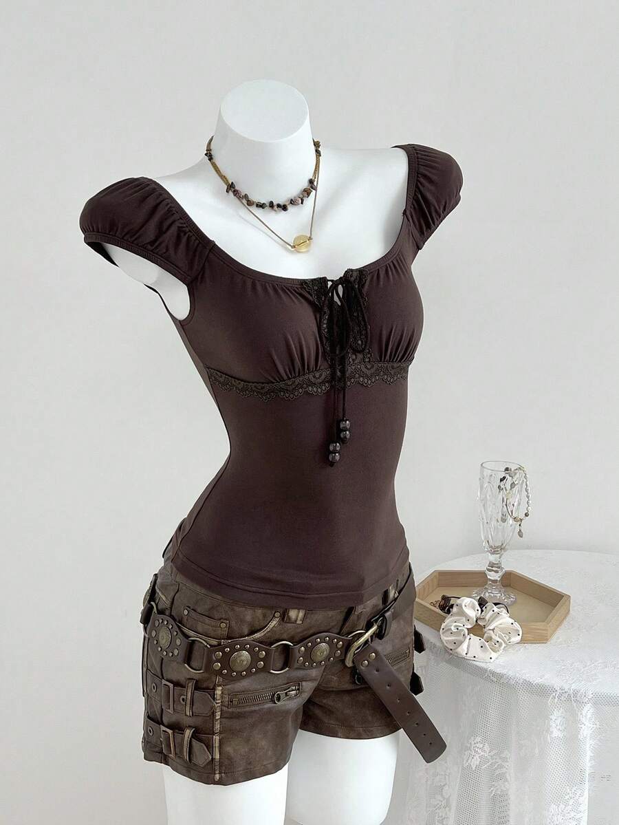 Women's brown slim-fit t-shirt with contrast lace trim, knot detail, scoop neck, and raglan cap sleeves.