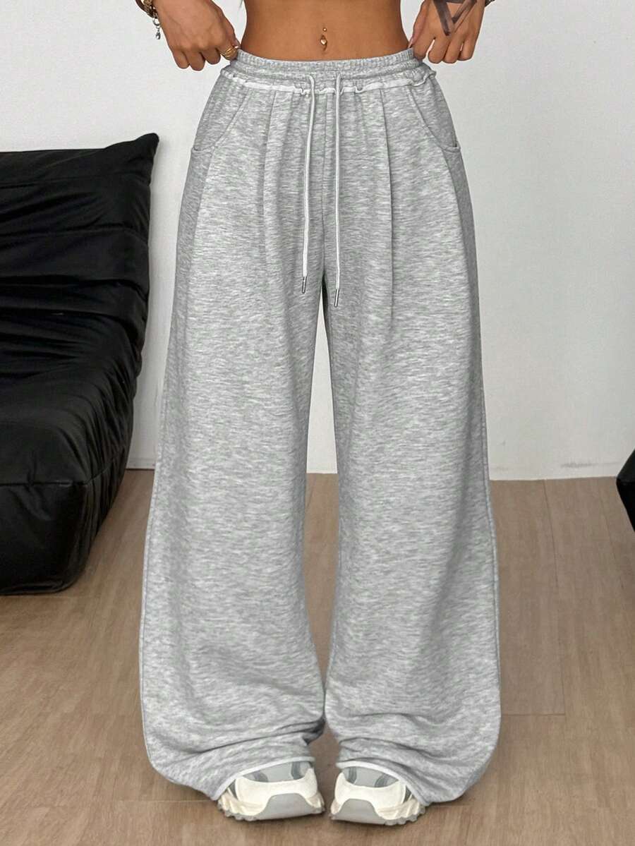 Women's casual straight leg baggy lounge pants in light grey with an adjustable drawstring waist and side pockets.