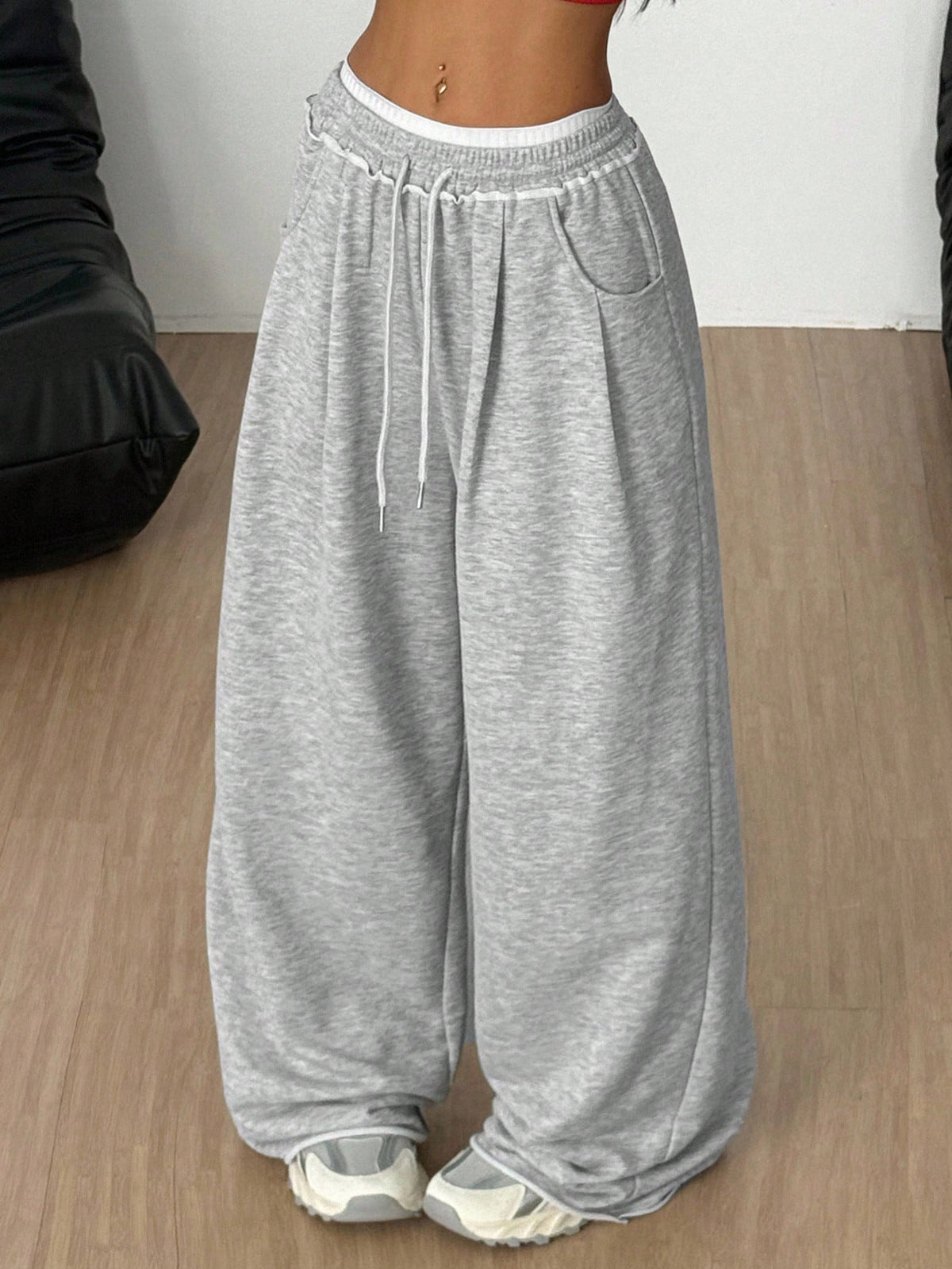 Women's casual straight leg baggy lounge pants in light grey with an adjustable drawstring waist and side pockets.