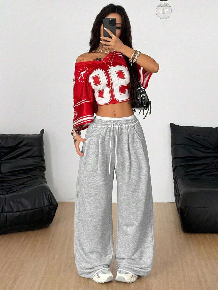 Women's casual straight leg baggy lounge pants in light grey with an adjustable drawstring waist and side pockets.