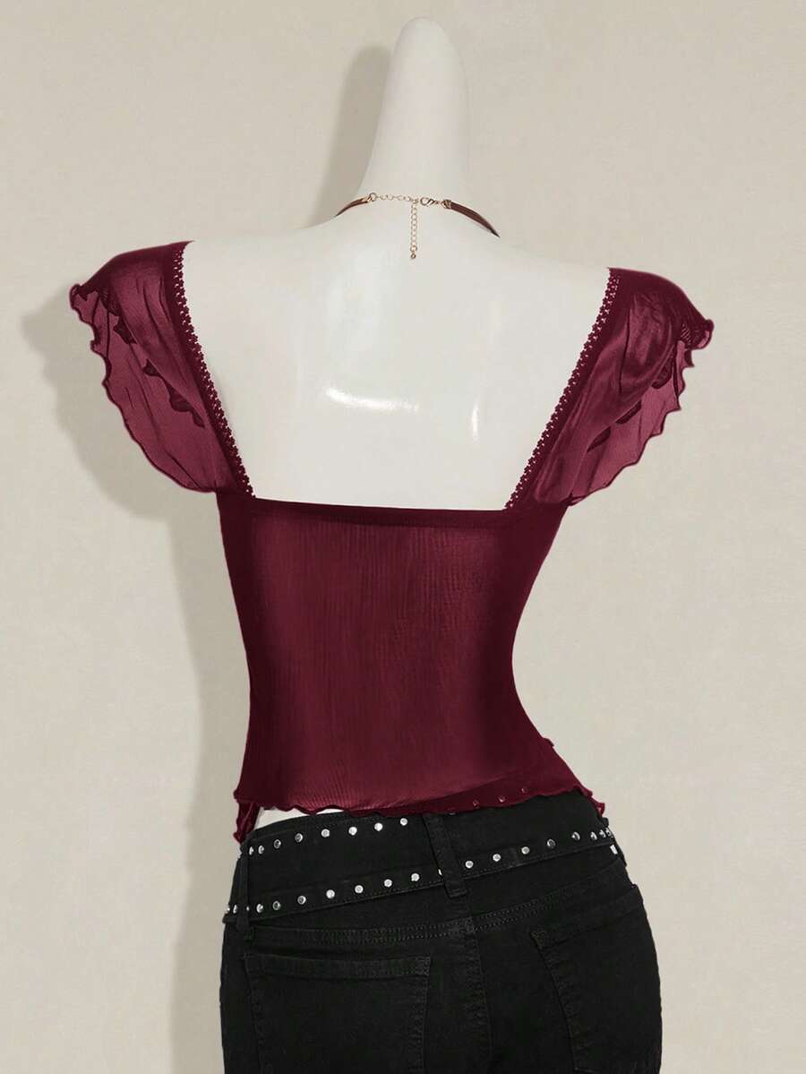 Black slim fit women's ruched front camisole tank top featuring contrast mesh inserts, square neckline, and an asymmetrical crop hem.