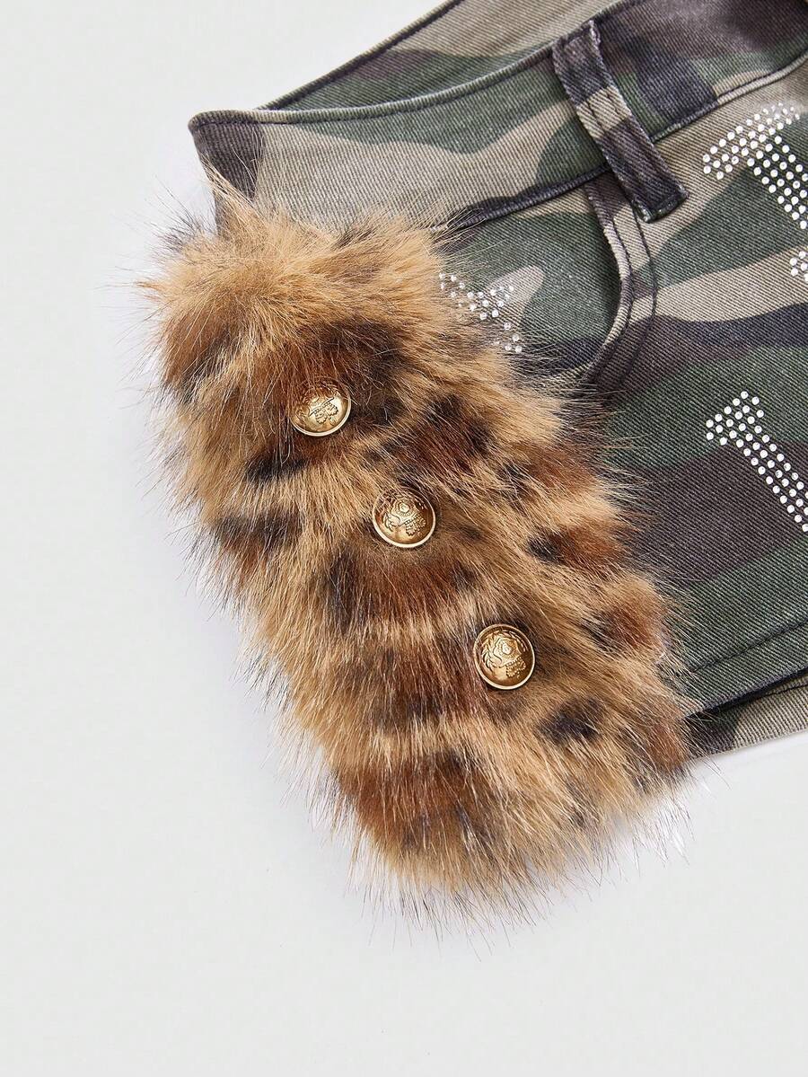 Army green Y2K K-pop style ultra low waist mini shorts with patchwork camo, star graphic details, rhinestone decoration, zipper fly, and pockets.