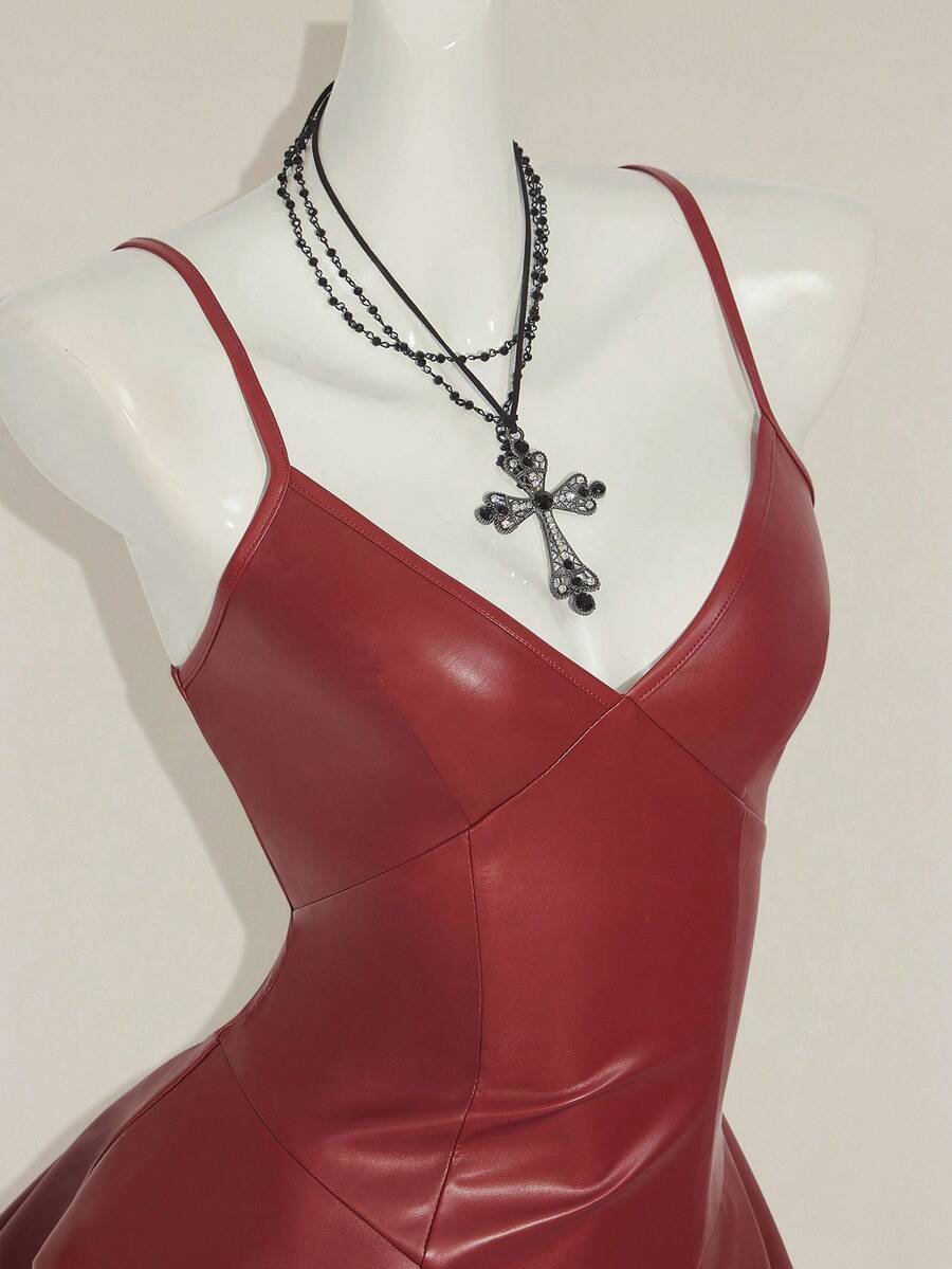 Women's Y2K PU leather mini dress with spaghetti straps, V-neckline, backless design, zipper closure, high waist, slim A-line fit, and layered tiered hem.