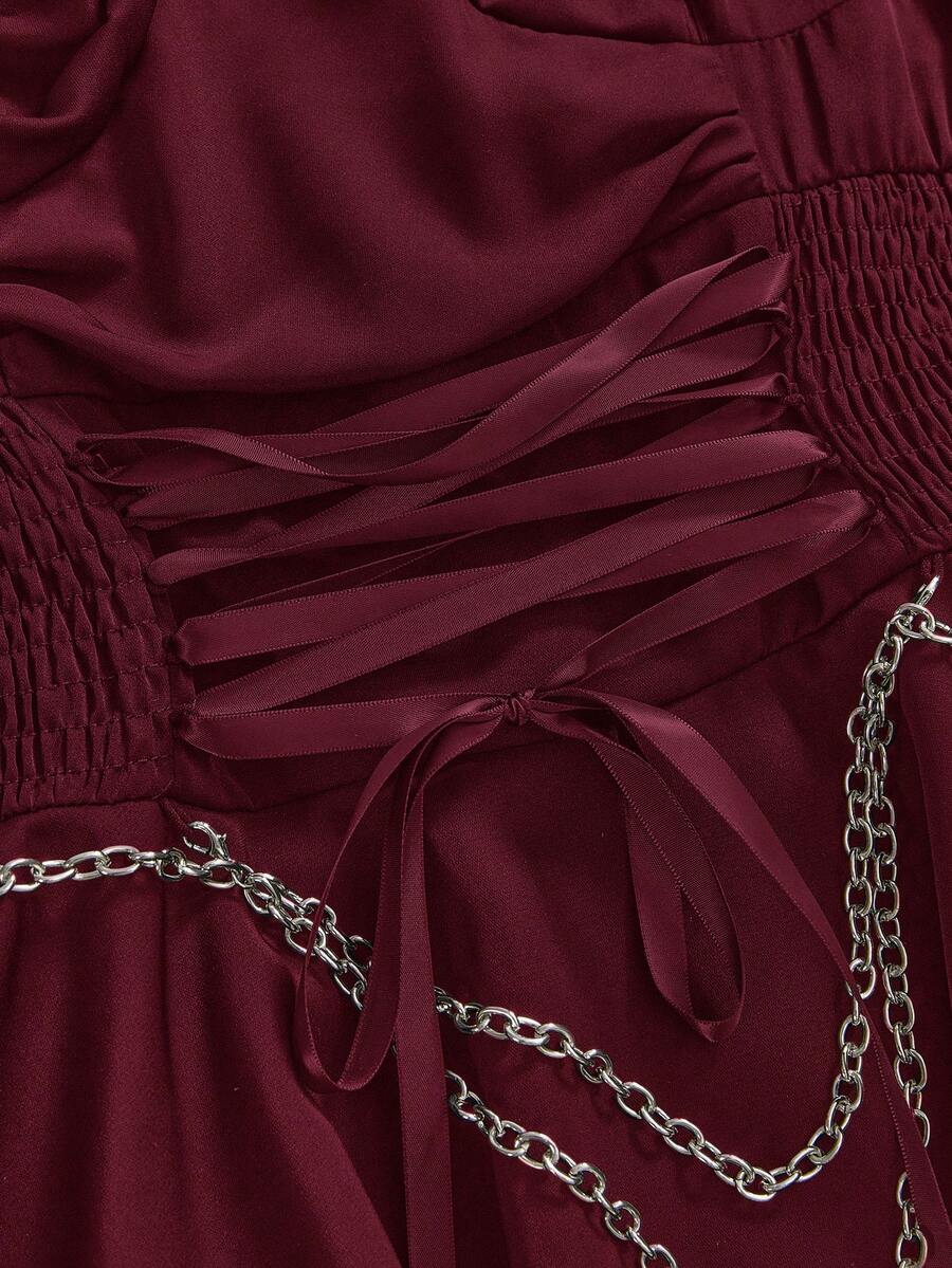 Women's vintage gothic cami dress with high-waist lace-up detail, spaghetti straps, zipper closure, and an asymmetrical knee-length hem.