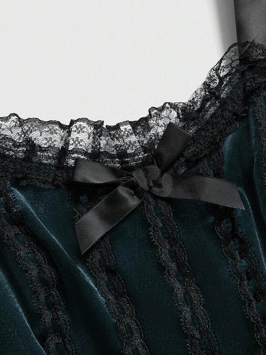 Gothic velvet halter mini dress with contrast lace trim, bow detail, lace-up accents, arm sleeves, layered hem, and cross pendant.