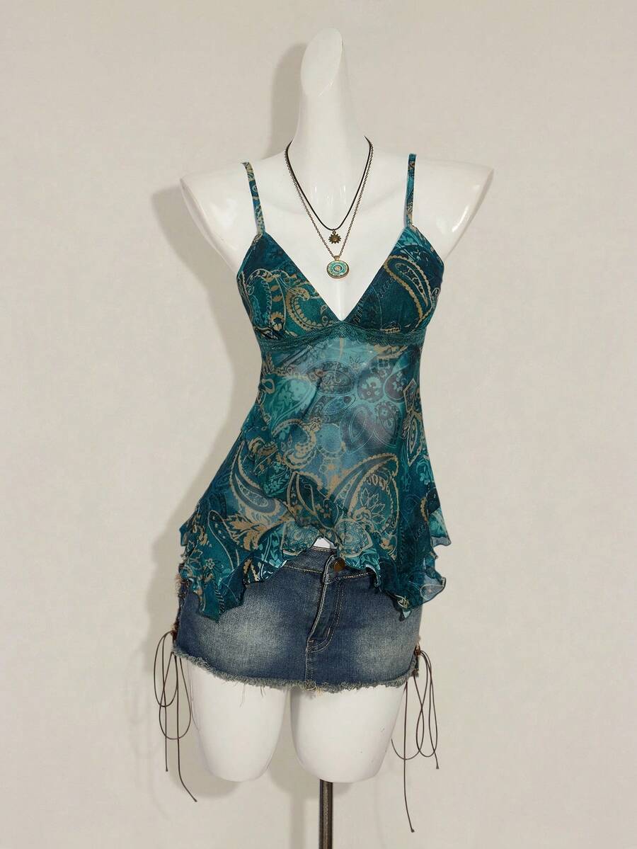 Women's graphic print camisole top featuring thin spaghetti straps, a backless cut, and an asymmetrical hem.