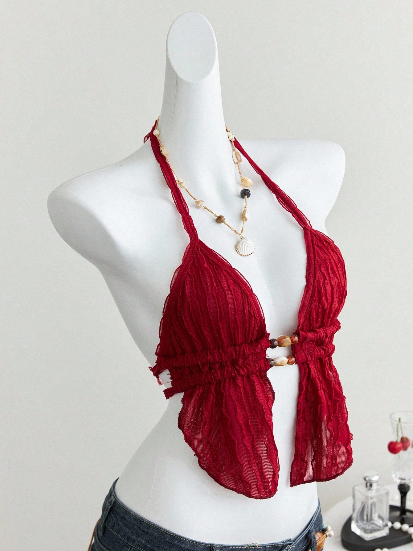 Women's textured halter camisole with pearl bead details, backless styling, asymmetrical hem, and micro crop slim fit