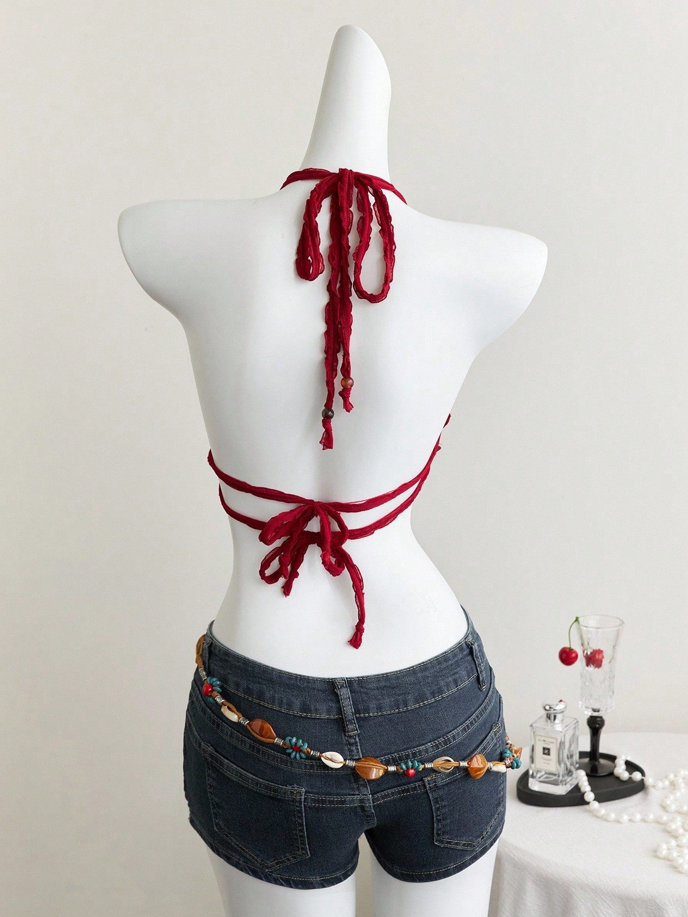 Women's textured halter camisole with pearl bead details, backless styling, asymmetrical hem, and micro crop slim fit