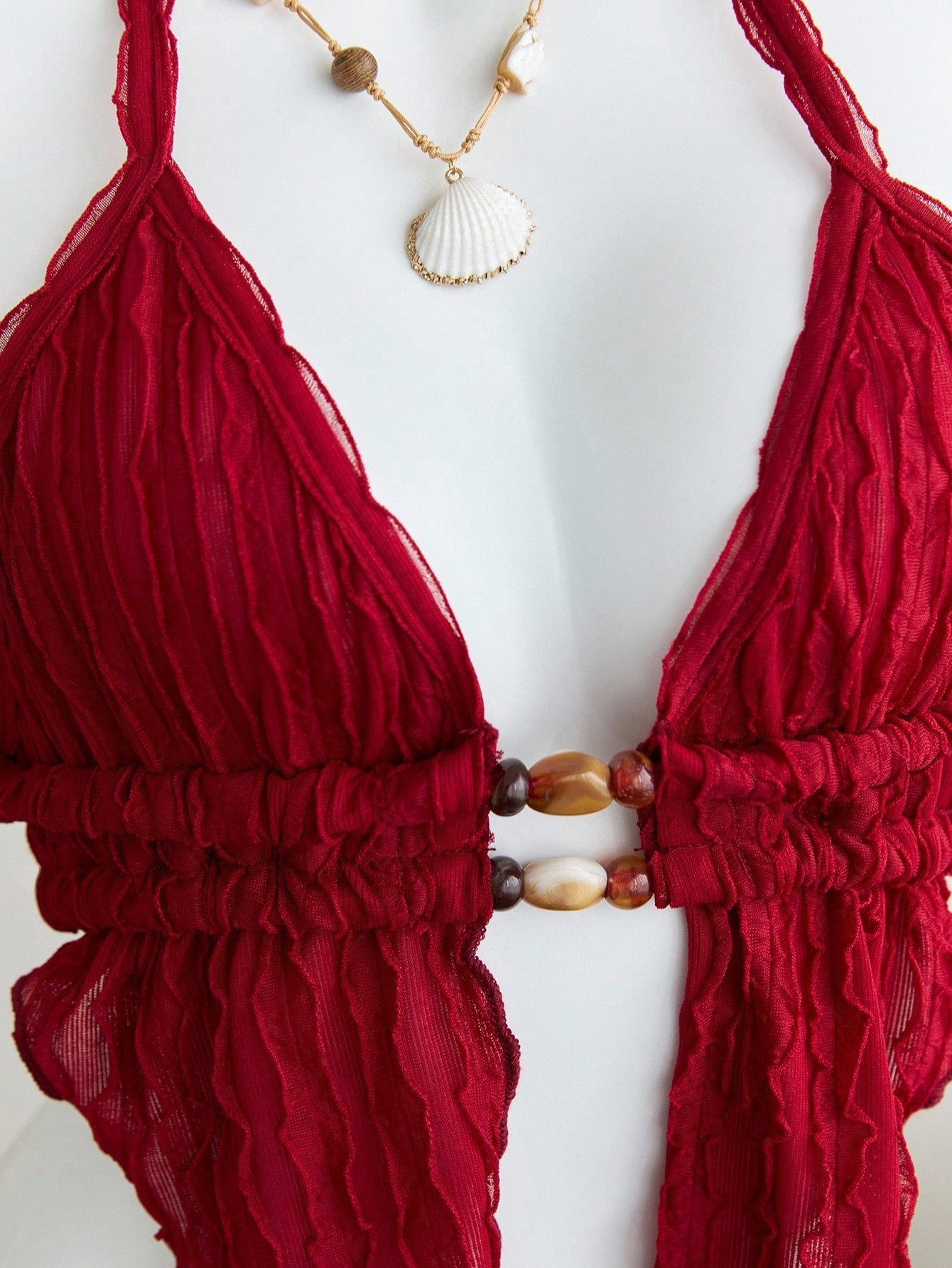 Women's textured halter camisole with pearl bead details, backless styling, asymmetrical hem, and micro crop slim fit