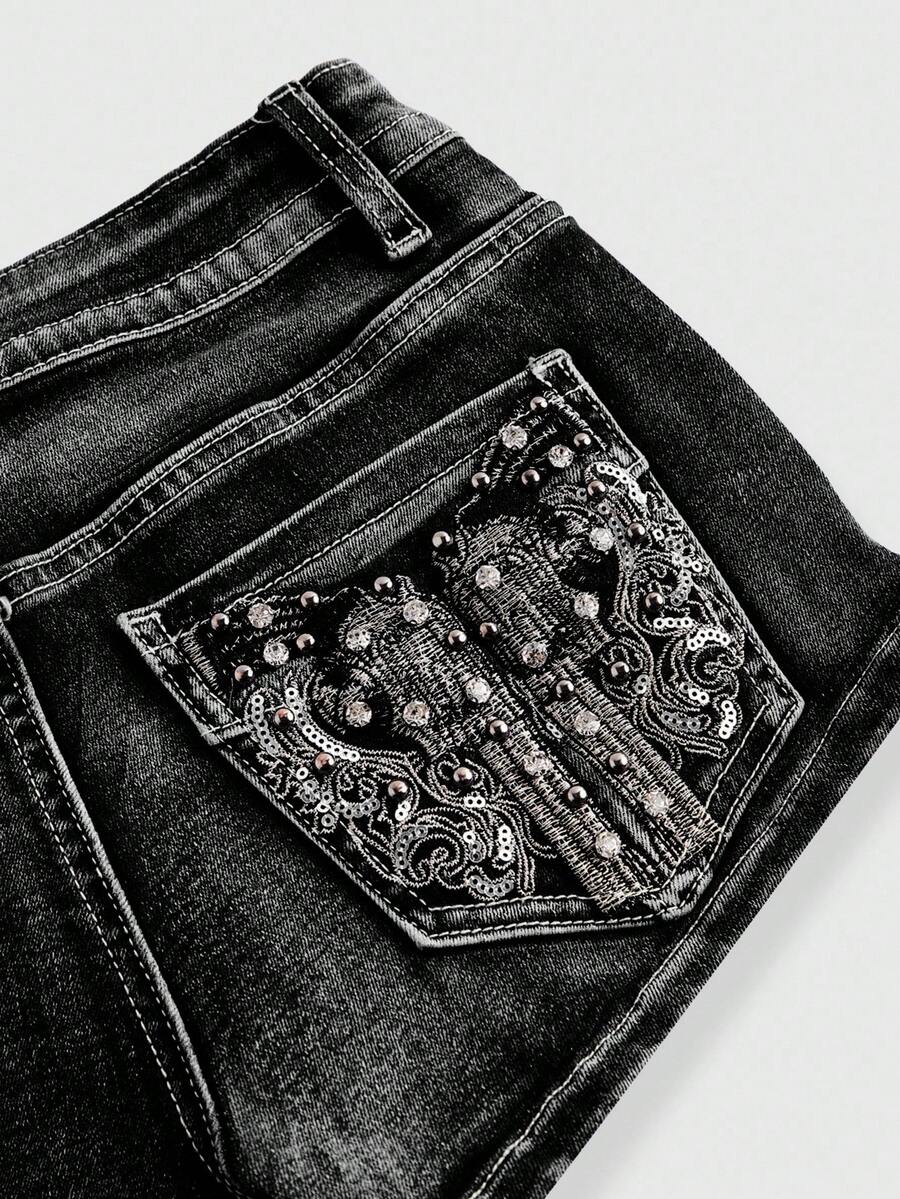 Women's ultra low waist skort with mini shorts length, zipper fly, pockets, pistol embroidery, and rhinestone details
