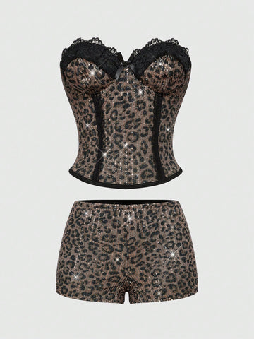 Black Y2K two-piece party set featuring a shiny sequin strapless micro crop bandeau top with cup details and bow, paired with matching lined mini shorts with contrast lace trim.