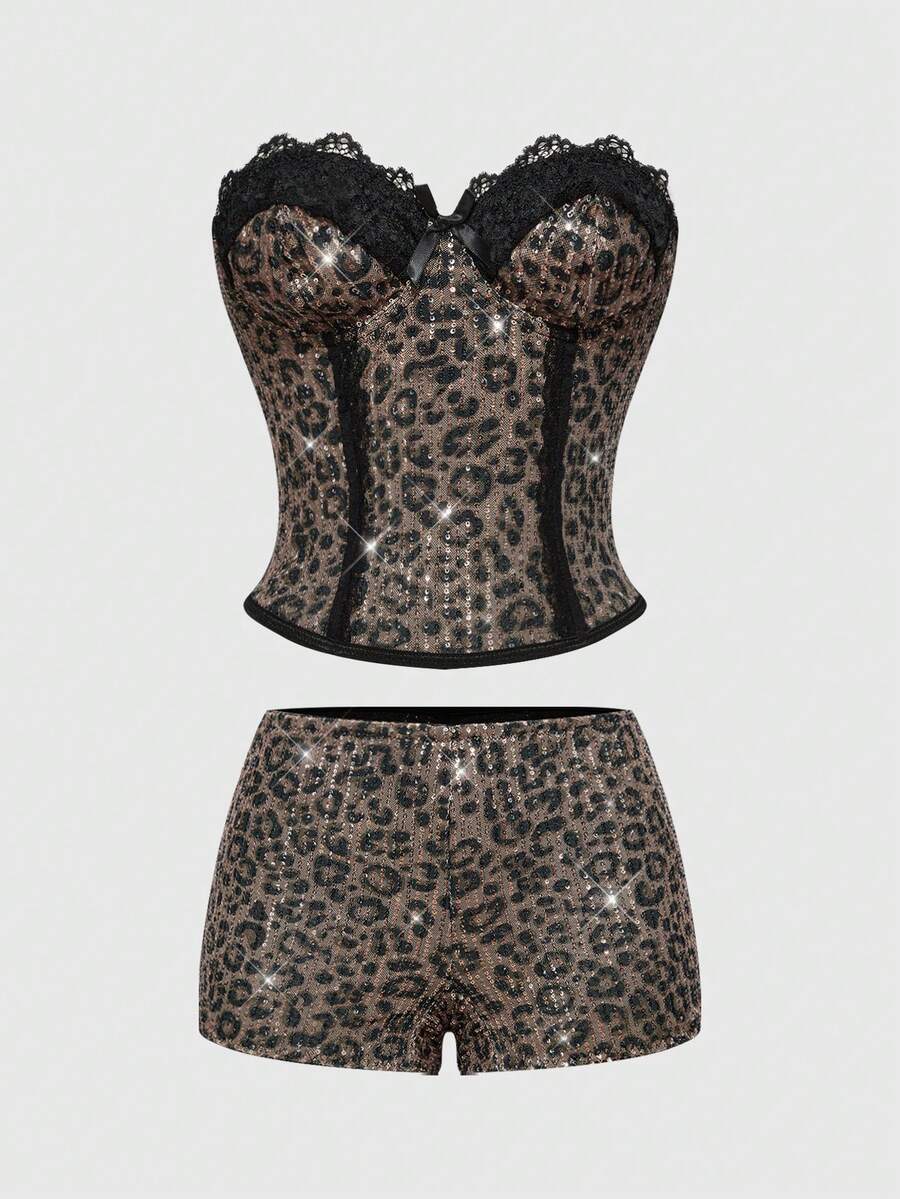 Black Y2K two-piece party set featuring a shiny sequin strapless micro crop bandeau top with cup details and bow, paired with matching lined mini shorts with contrast lace trim.