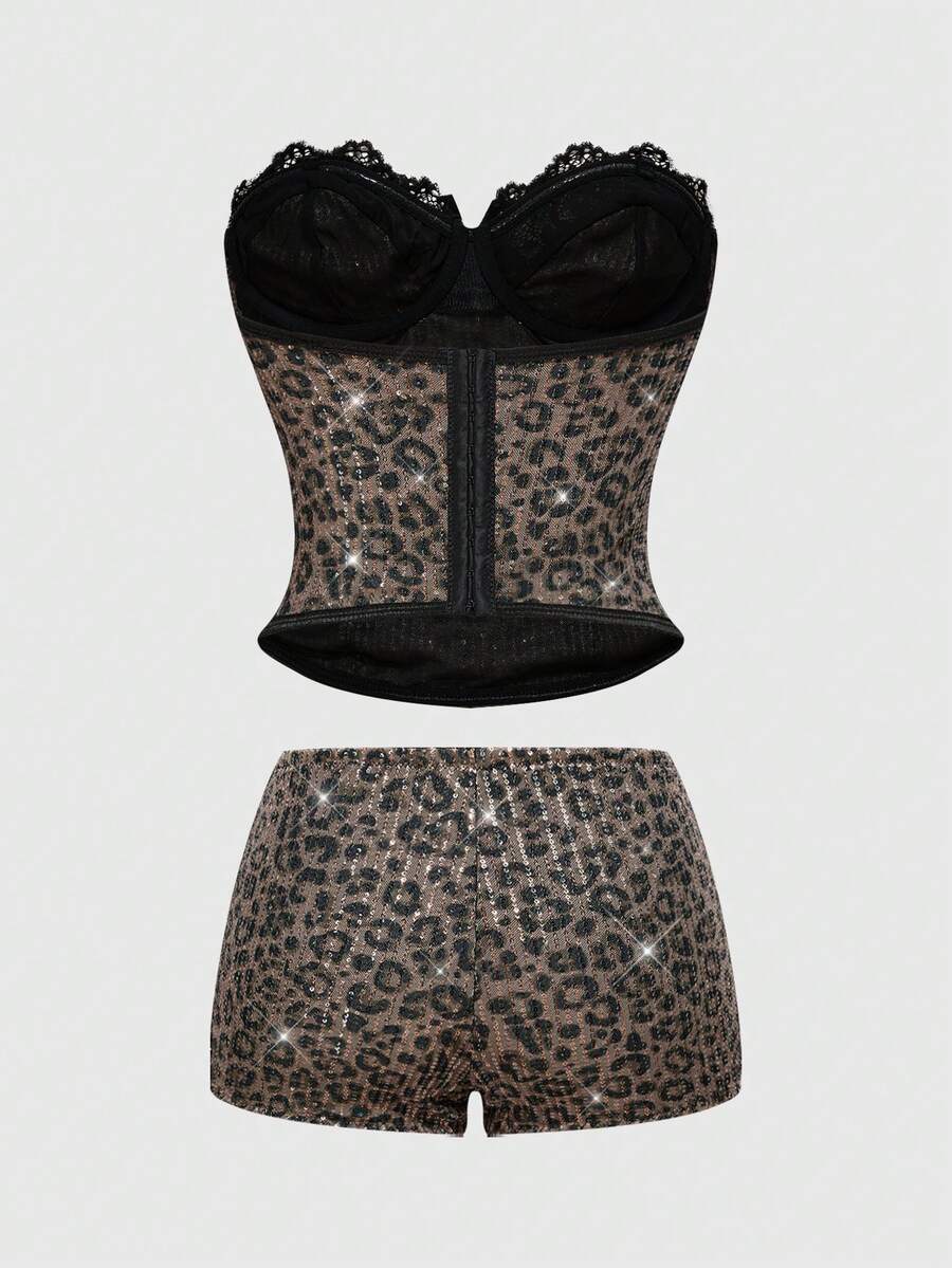 Black Y2K two-piece party set featuring a shiny sequin strapless micro crop bandeau top with cup details and bow, paired with matching lined mini shorts with contrast lace trim.