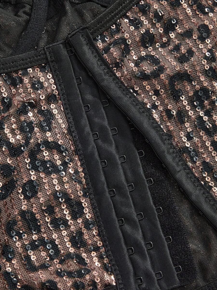 Black Y2K two-piece party set featuring a shiny sequin strapless micro crop bandeau top with cup details and bow, paired with matching lined mini shorts with contrast lace trim.