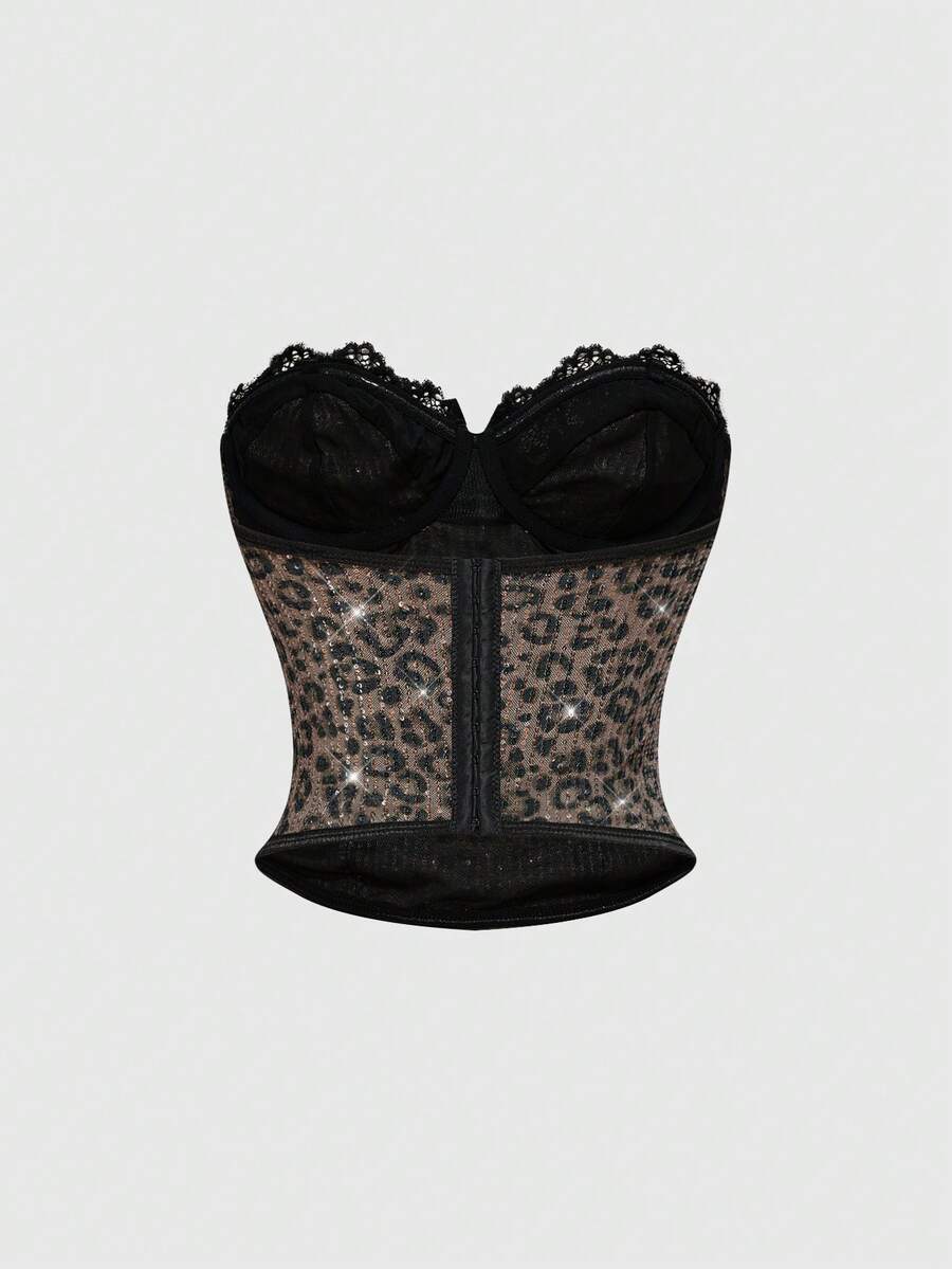 Black Y2K two-piece party set featuring a shiny sequin strapless micro crop bandeau top with cup details and bow, paired with matching lined mini shorts with contrast lace trim.