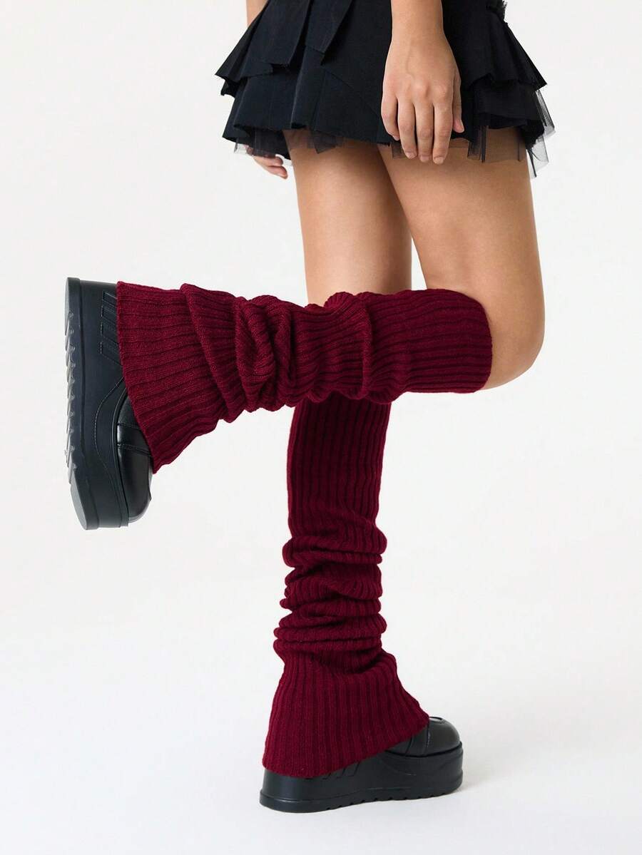 Pair of women's extra long knitted leg warmers featuring a gothic grunge design with subtle ruffle detailing.