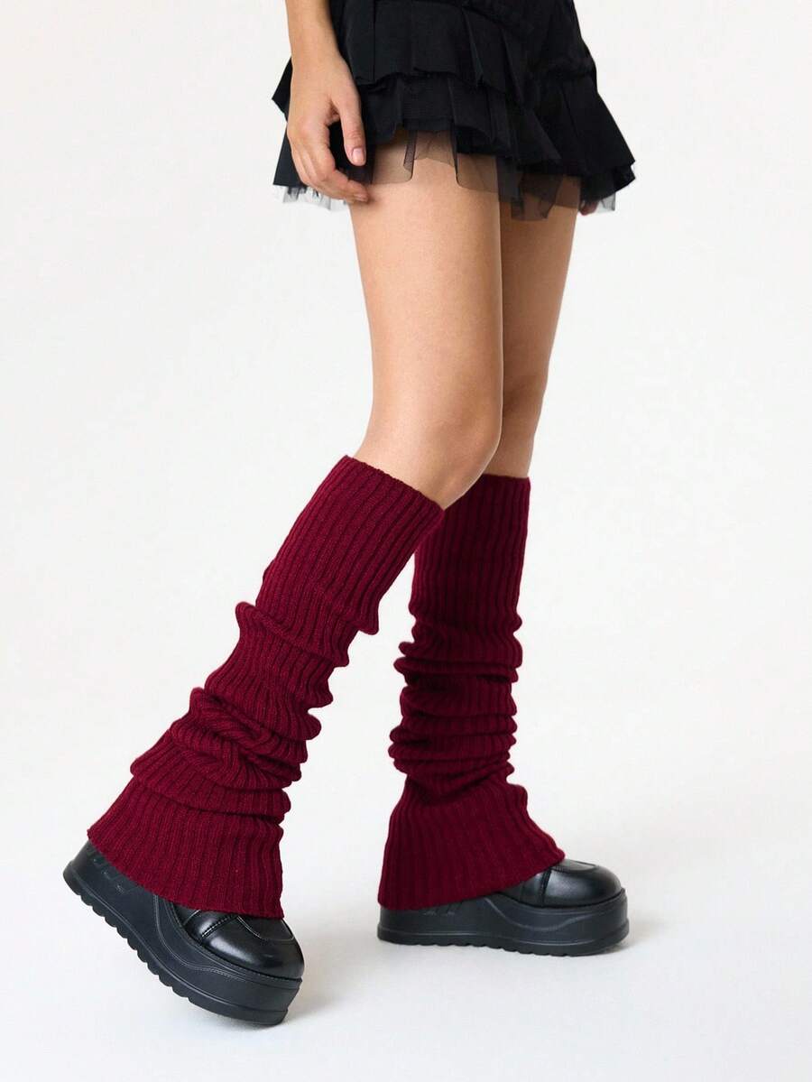 Pair of women's extra long knitted leg warmers featuring a gothic grunge design with subtle ruffle detailing.