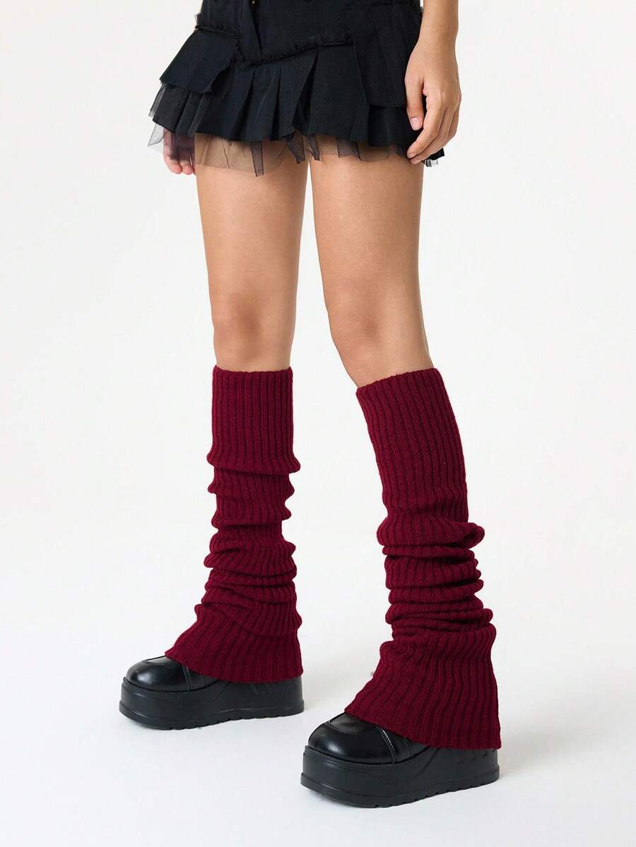 Pair of women's extra long knitted leg warmers featuring a gothic grunge design with subtle ruffle detailing.