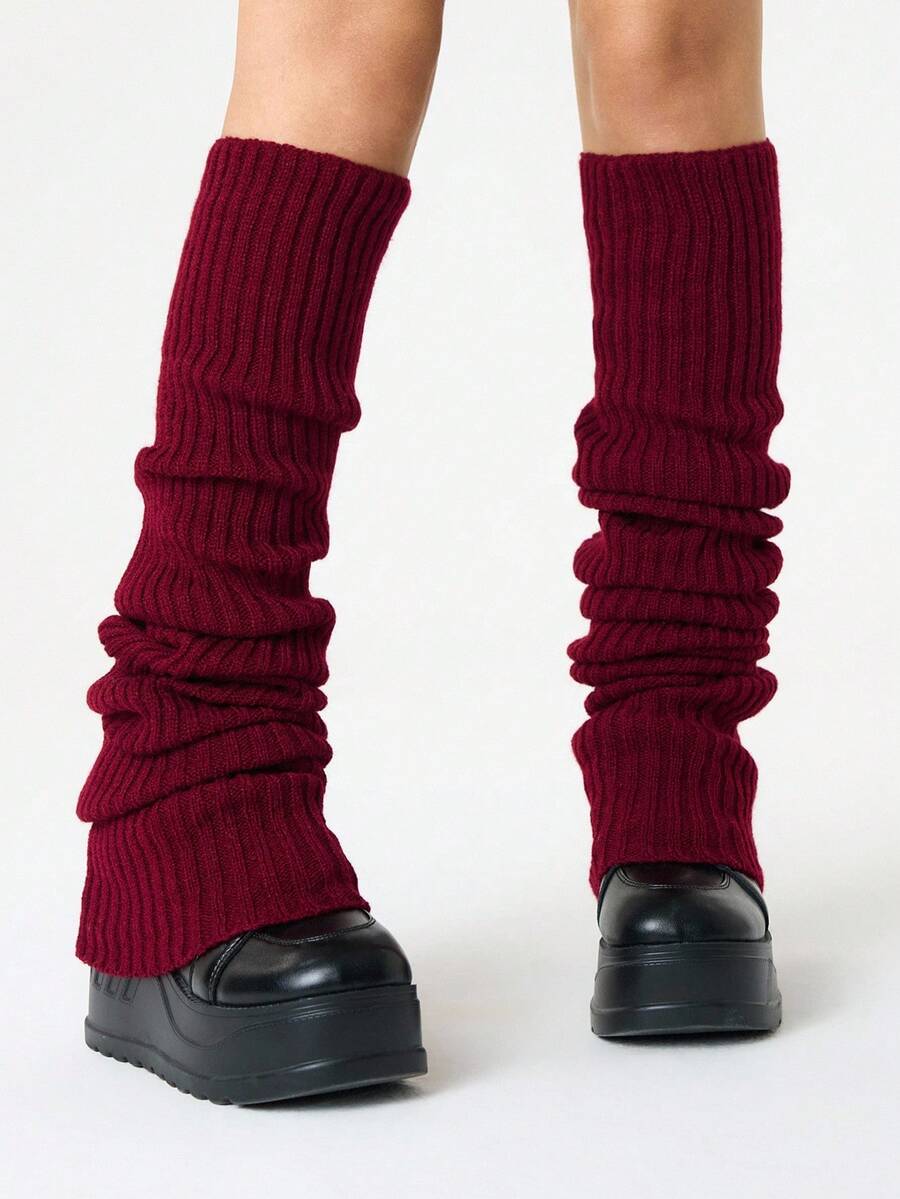 Pair of women's extra long knitted leg warmers featuring a gothic grunge design with subtle ruffle detailing.