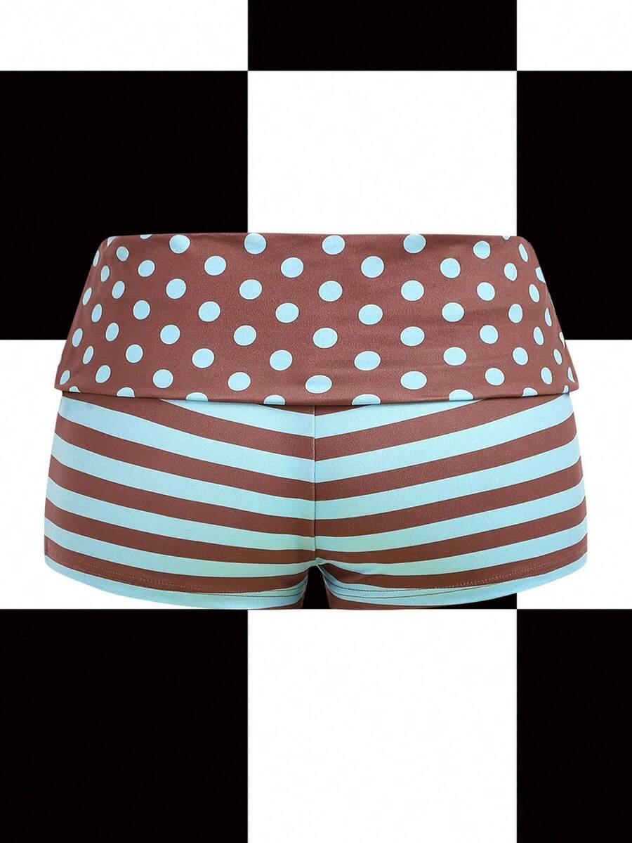 Women's black low waist mini track shorts with contrast polka dot, striped, geometric, and plant-inspired print details, elastic waistband, and skinny fit