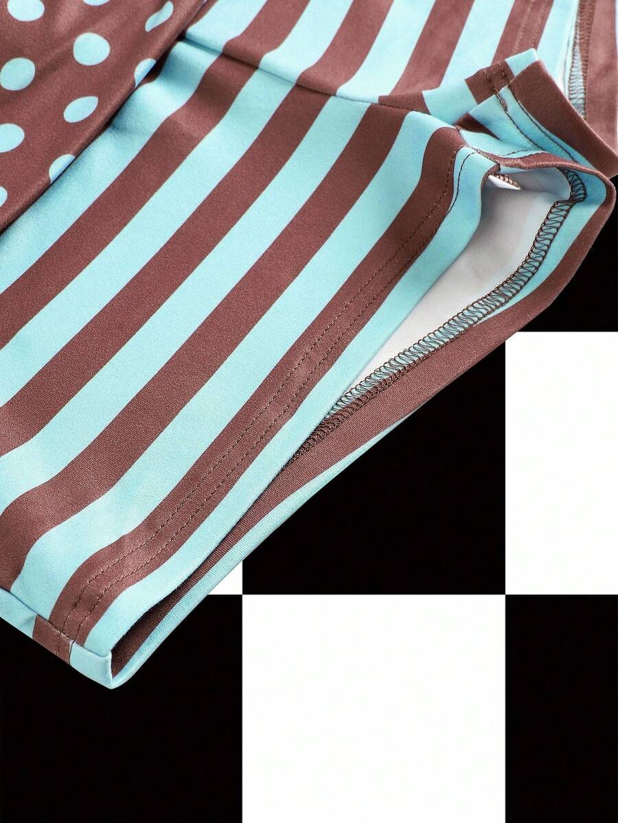 Women's black low waist mini track shorts with contrast polka dot, striped, geometric, and plant-inspired print details, elastic waistband, and skinny fit