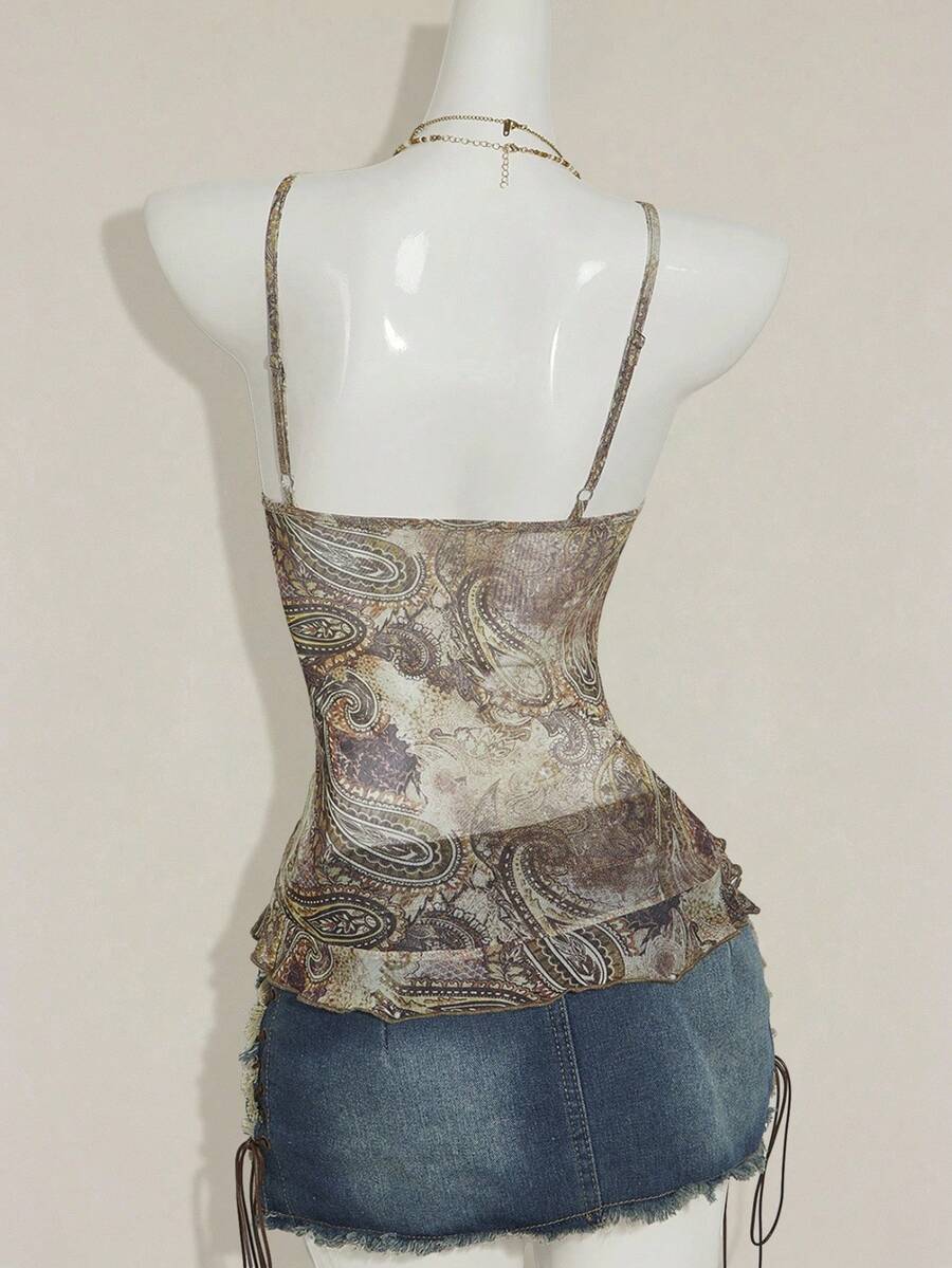 Women's graphic print camisole top featuring thin spaghetti straps, a backless cut, and an asymmetrical hem.