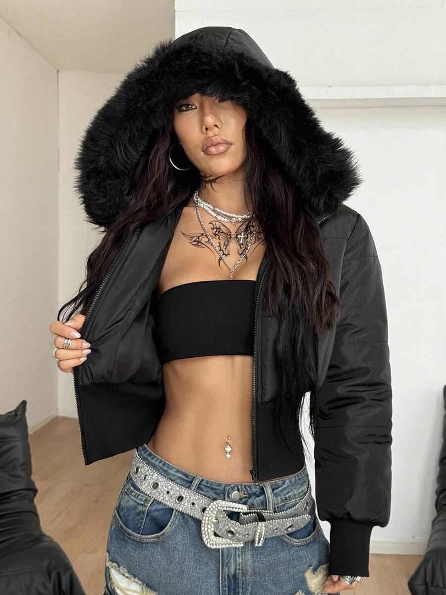 Women's brown cropped puffer jacket featuring a faux fur trimmed hood, front zipper, and ribbed hem.