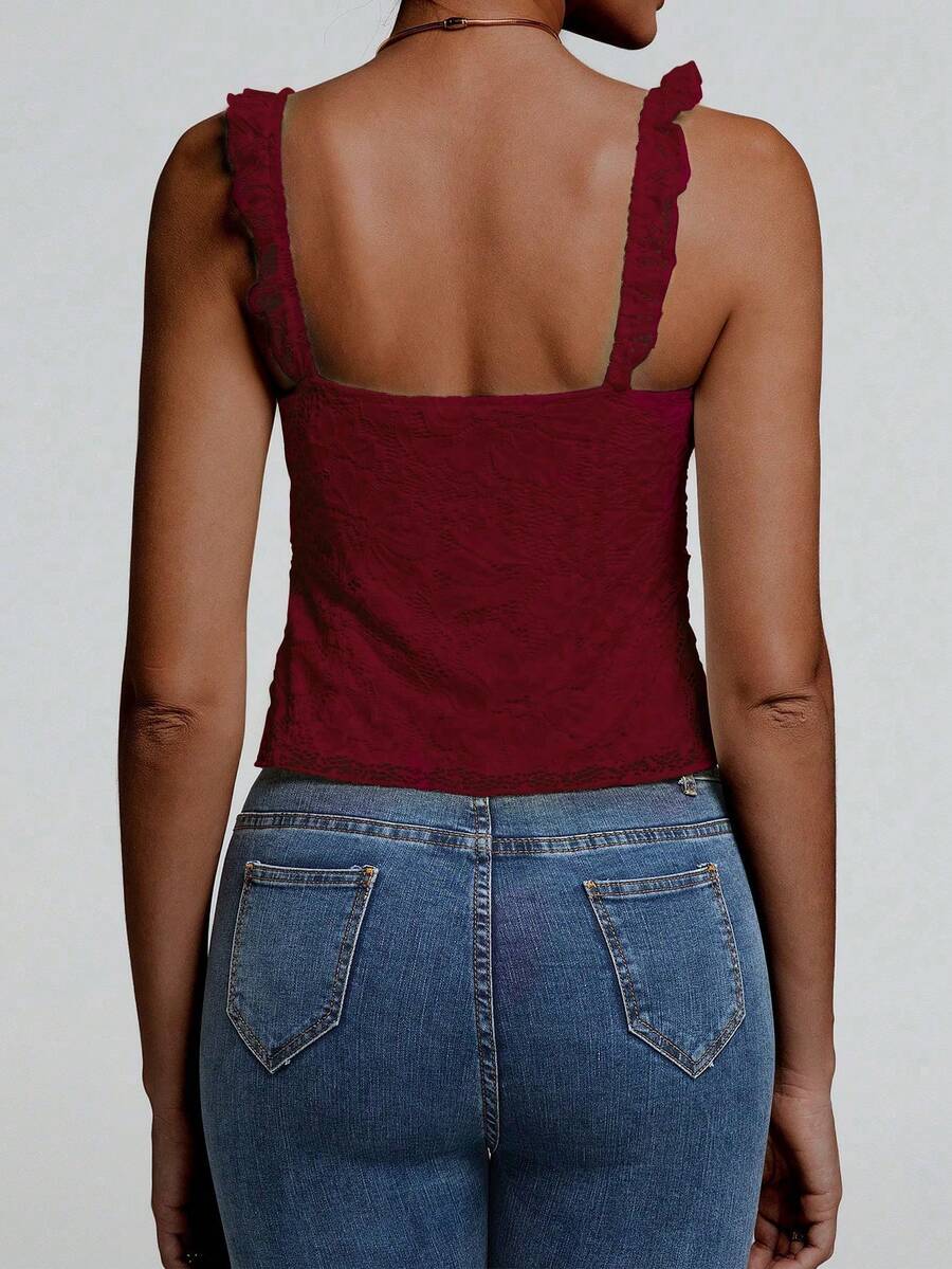 Sleeveless cami tank top featuring contrast lace patchwork design, ruffle spaghetti straps, and bow decor.