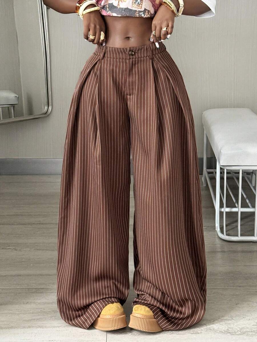 Women's brown striped wide leg pants with a low waist, curved hem, and loose casual fit in woven fabric.