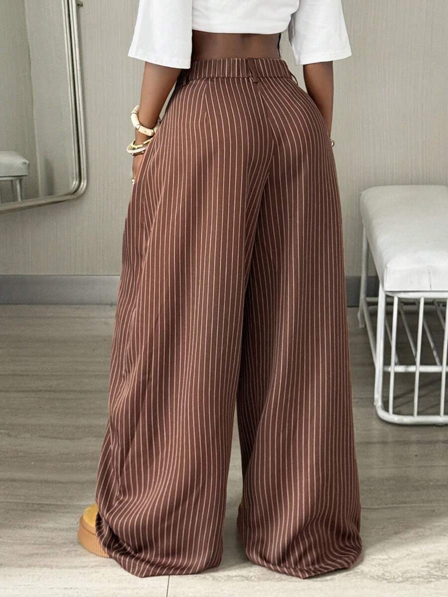 Women's brown striped wide leg pants with a low waist, curved hem, and loose casual fit in woven fabric.
