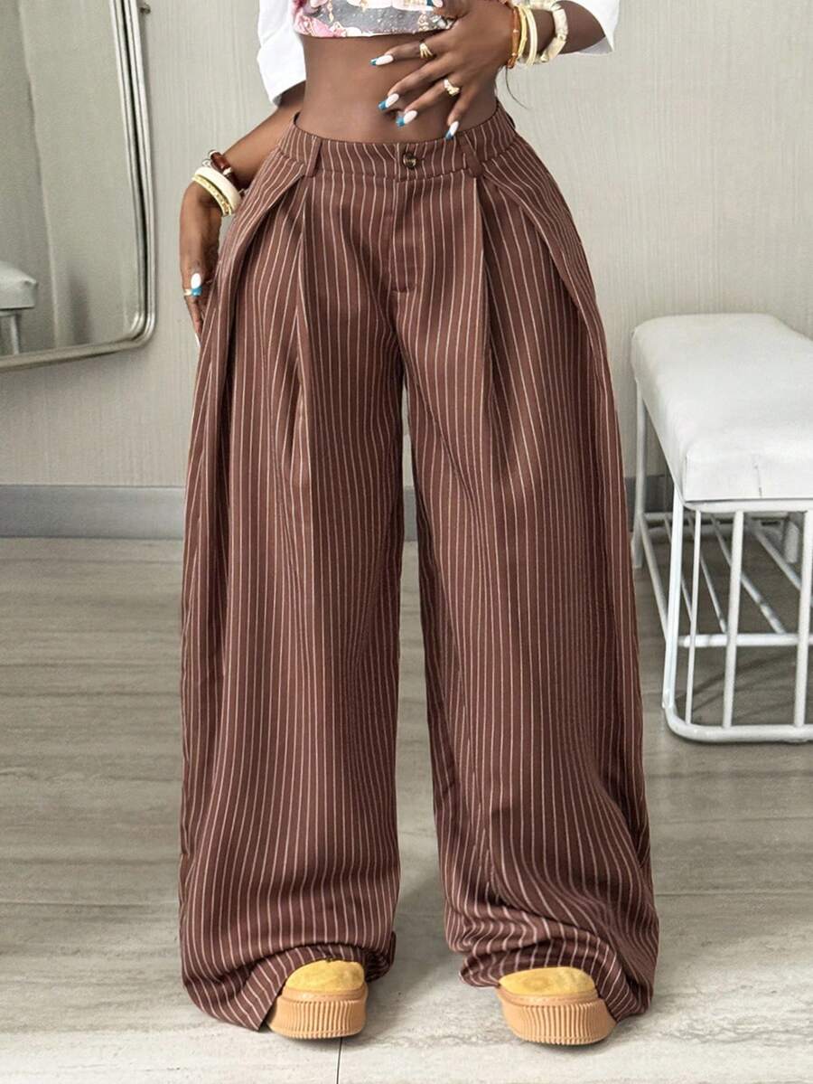 Women's brown striped wide leg pants with a low waist, curved hem, and loose casual fit in woven fabric.