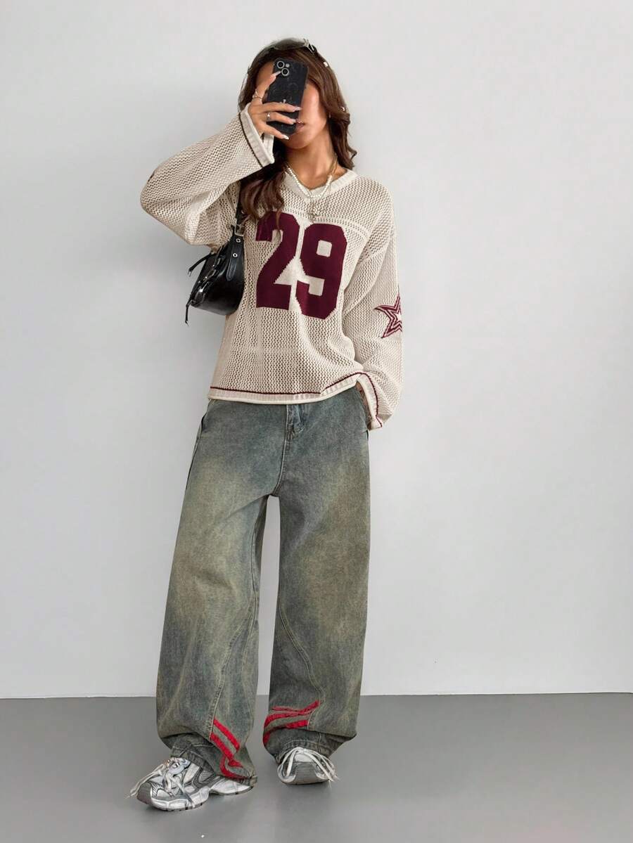 Women's oversized long sleeve knit pullover sweater with round neck, drop shoulder design, and front pocket detail.