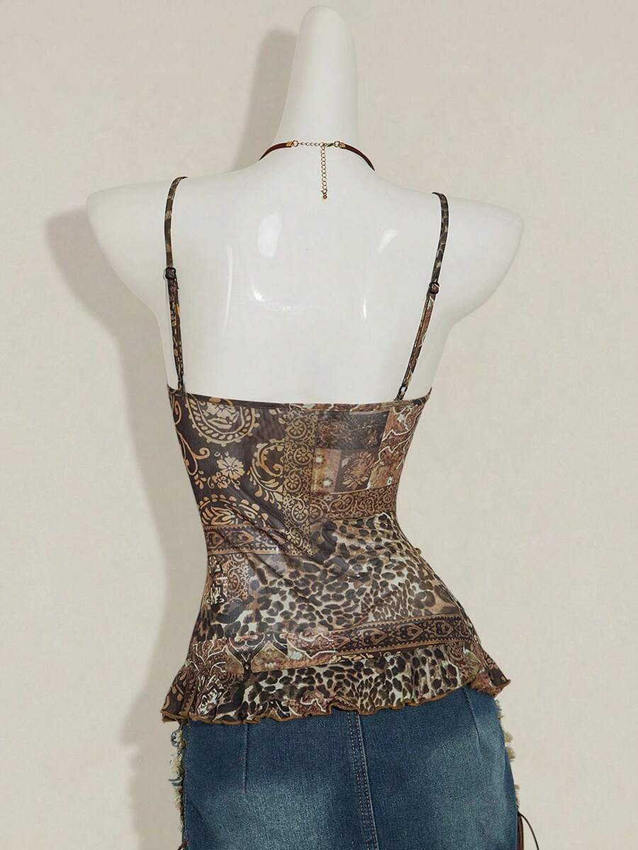 Women's graphic print camisole top featuring thin spaghetti straps, a backless cut, and an asymmetrical hem.