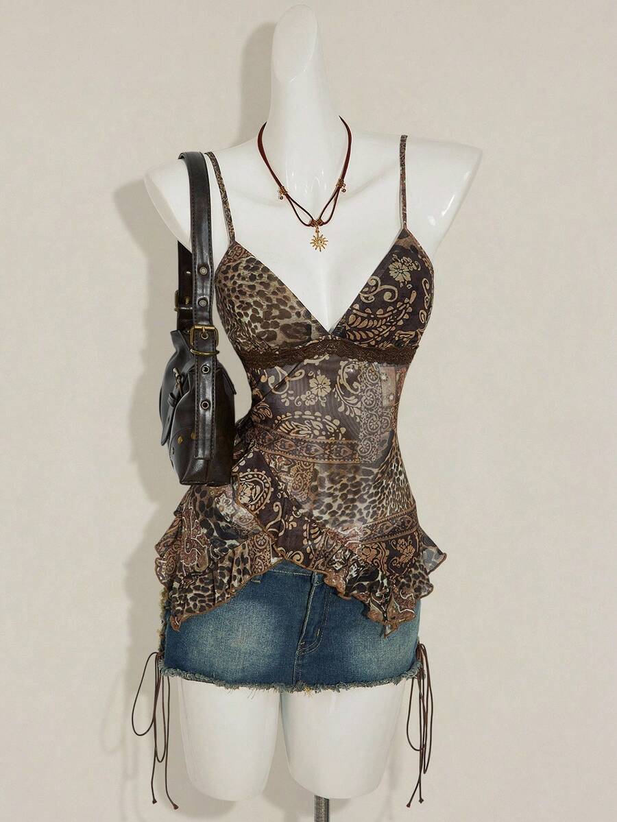 Women's graphic print camisole top featuring thin spaghetti straps, a backless cut, and an asymmetrical hem.