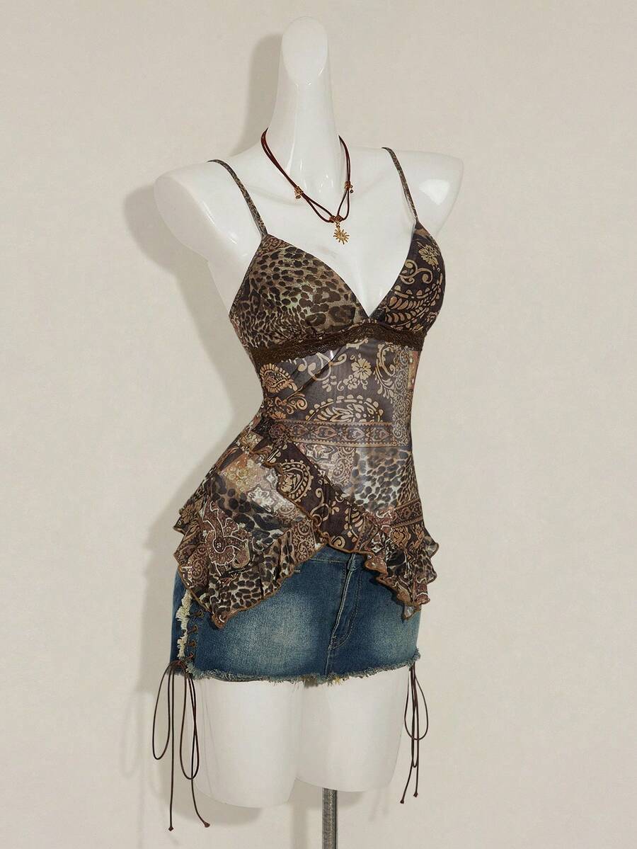 Women's graphic print camisole top featuring thin spaghetti straps, a backless cut, and an asymmetrical hem.