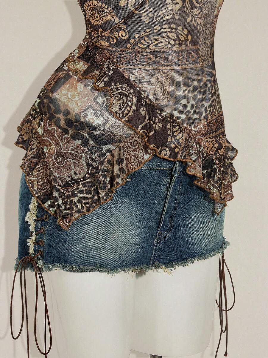Women's graphic print camisole top featuring thin spaghetti straps, a backless cut, and an asymmetrical hem.