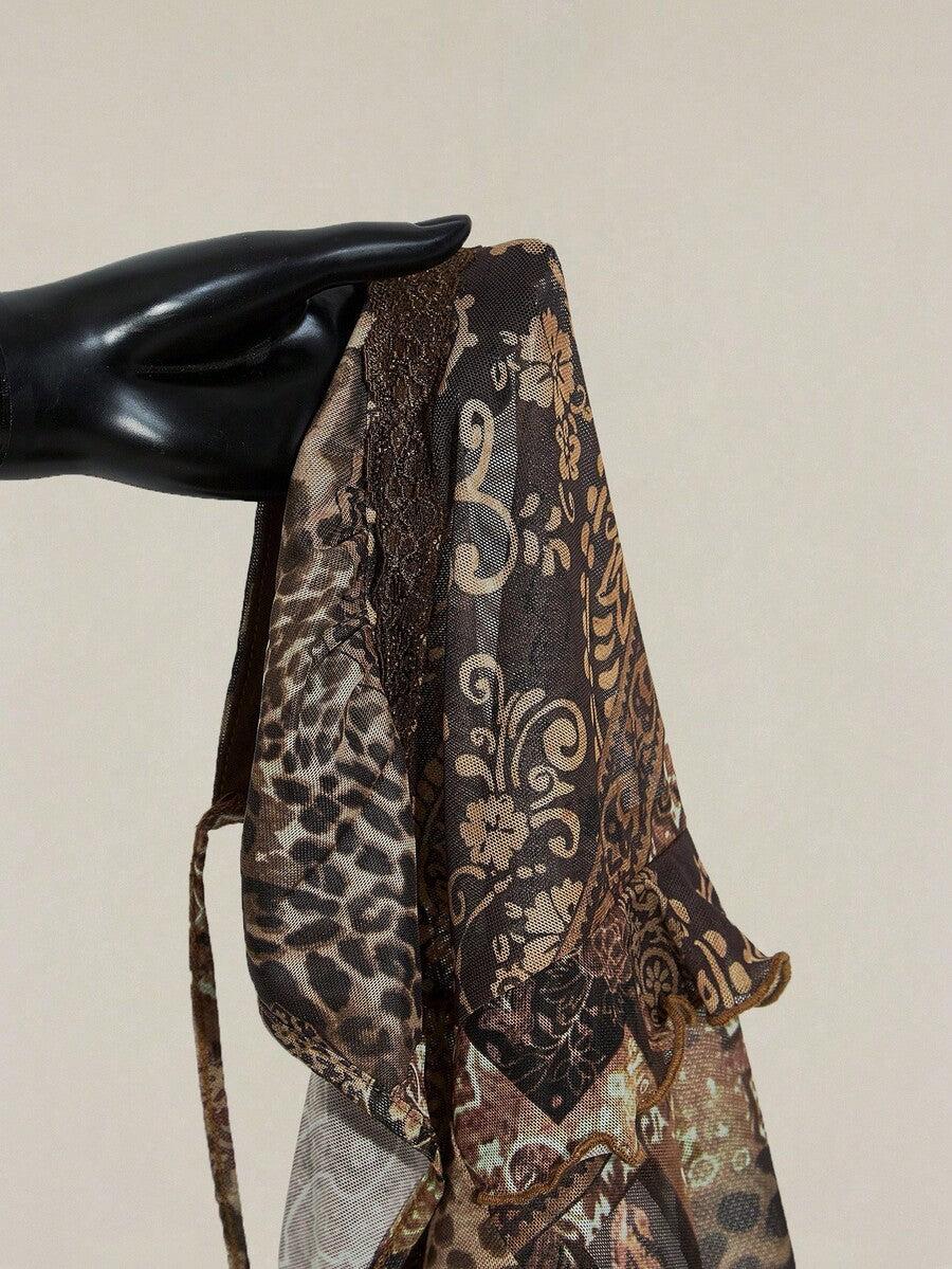 Women's graphic print camisole top featuring thin spaghetti straps, a backless cut, and an asymmetrical hem.