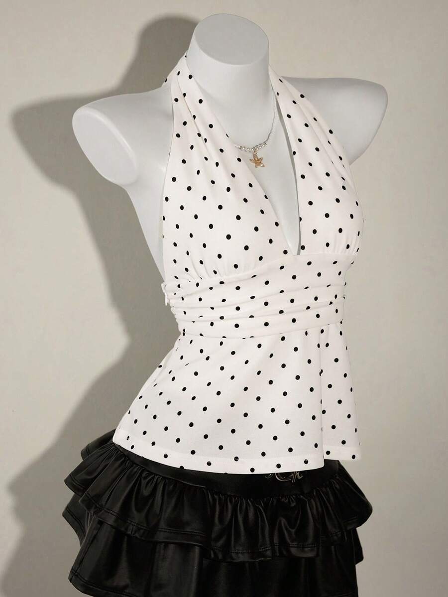 White women's deep V-neck halter tank top with ruched waist, backless design, rib-knit texture, and ruffle hem